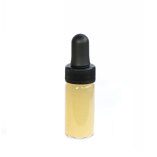 9 ml Yawanawa Sananga eye-drop bottle: clear glass filled with amber-colored liquid and topped with a black rubber dropper