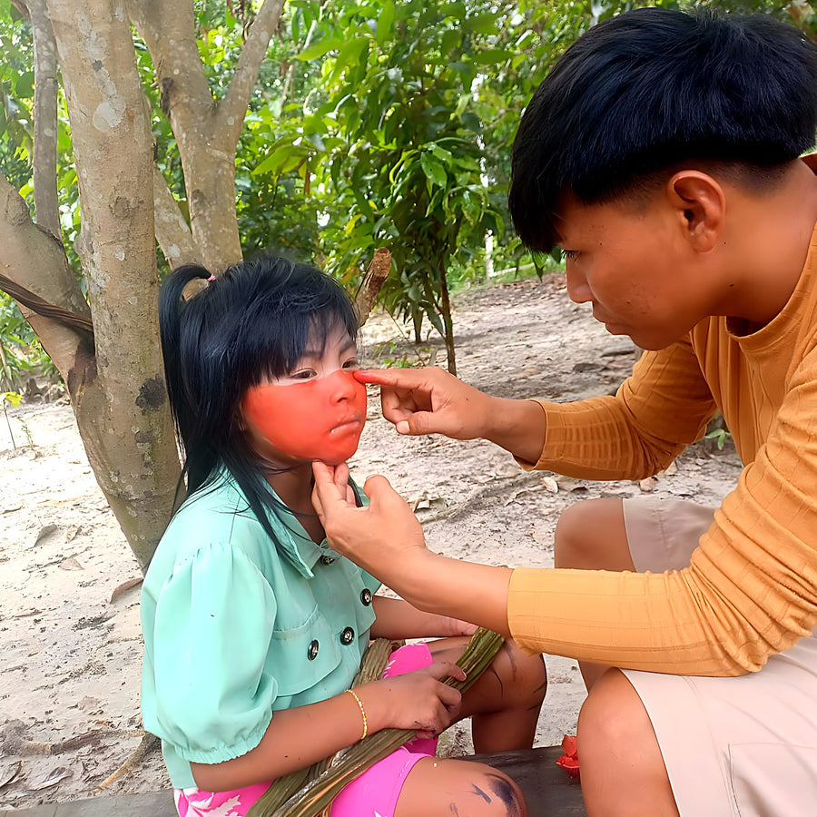Shara Kamanawa receiving body paint from her father for spiritual protection, haux