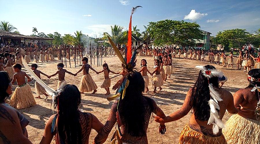 Yawanawá tribespeople dancing in a circle during their annual festival