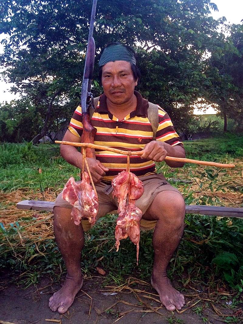 A Yawanawá hunter returns from a collective hunt — the catch is always shared equally